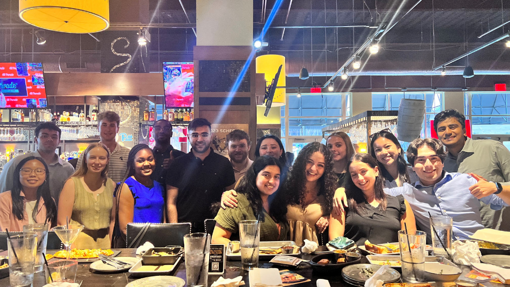 Jada Horton (pictured near the center in the blue shirt) celebrated National Intern Day with other interns at a local restaurant in Pittsburgh, PA during her summer internship with PPG.
